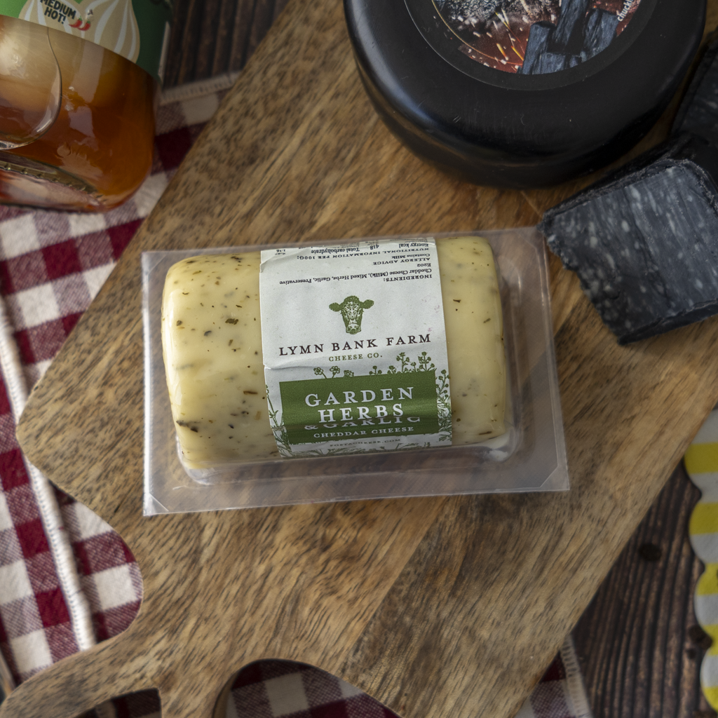 Garden Herbs Cheddar with Charcoal Cheddar and cheeseboard accompaniments.