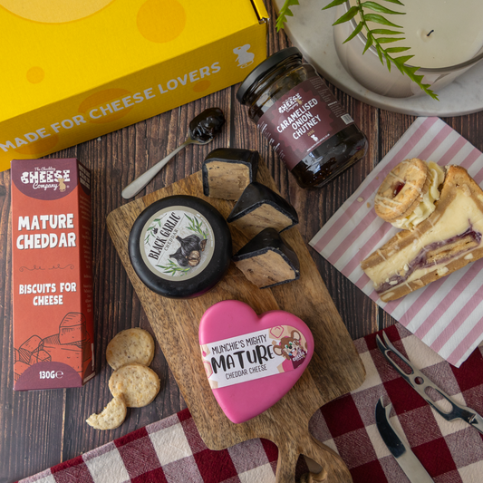 1. Mum Melt Gift Box spread with Mature Cheddar, Black Garlic Cheddar, caramelised onion chutney, biscuits and a cheese toastie.