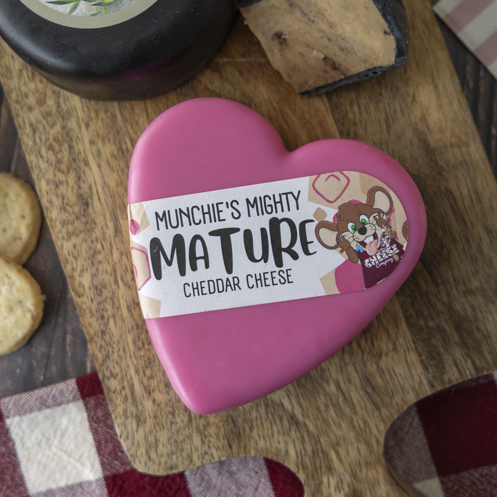 Munchie’s Mighty Mature Cheddar heart with crackers and cheeseboard accompaniments.