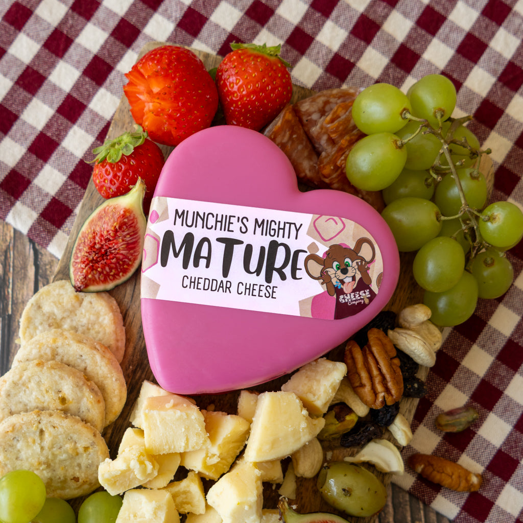 Chuckling Cheese Mighty Mature Heart Cheddar grazing board with grapes, crackers and charcuterie