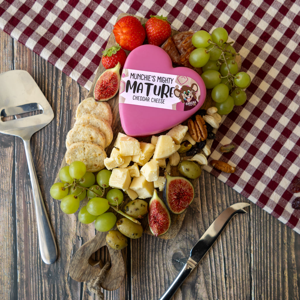 Mighty Mature Heart Cheddar Truckle cheeseboard with grapes, crackers and savoury accompaniments