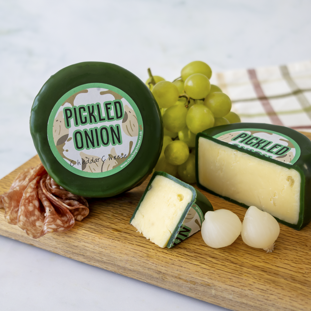 Chuckling Cheese Pickled Onion Cheddar Truckle with grapes, pickled onions and charcuterie