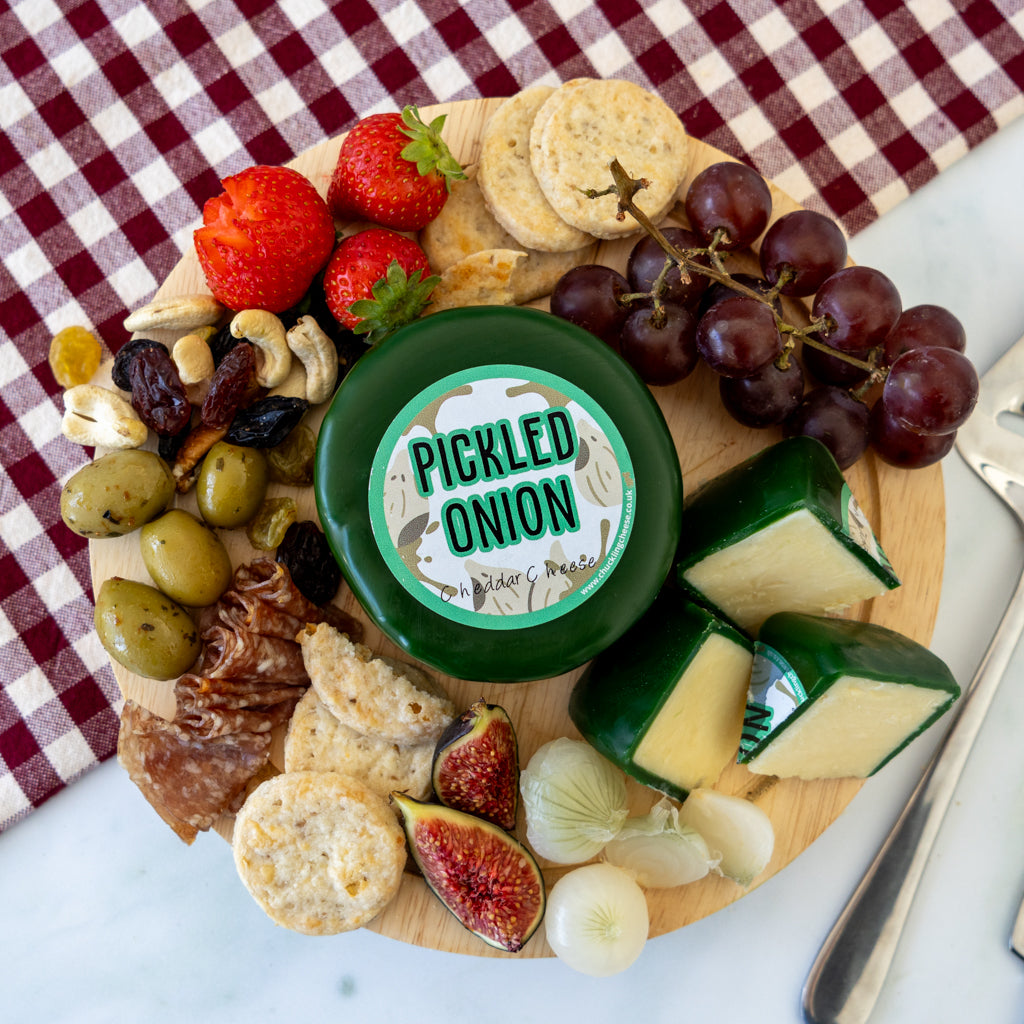 Chuckling Cheese Pickled Onion Cheddar Truckle platter with crackers, grapes, figs and cheeseboard accompaniments