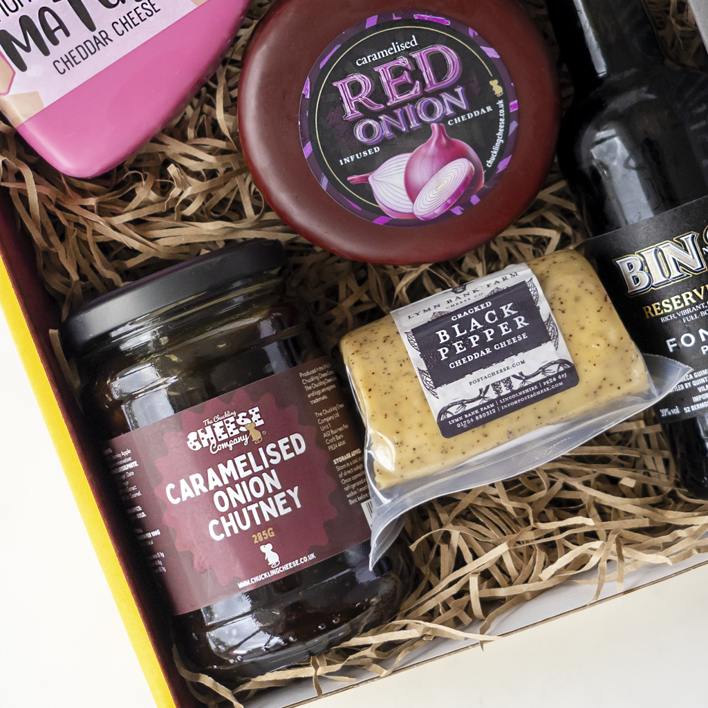 Port & Cheese Gift Box with Caramelised Red Onion Cheddar, Black Pepper Cheddar, caramelised onion chutney and a bottle of port.