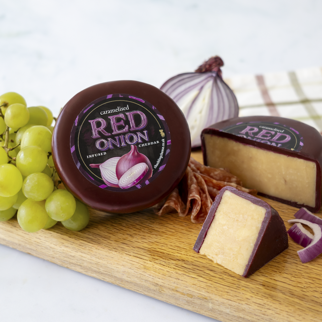 Chuckling Cheese Caramelised Red Onion Cheddar Truckle with grapes, onion and cheese wedges
