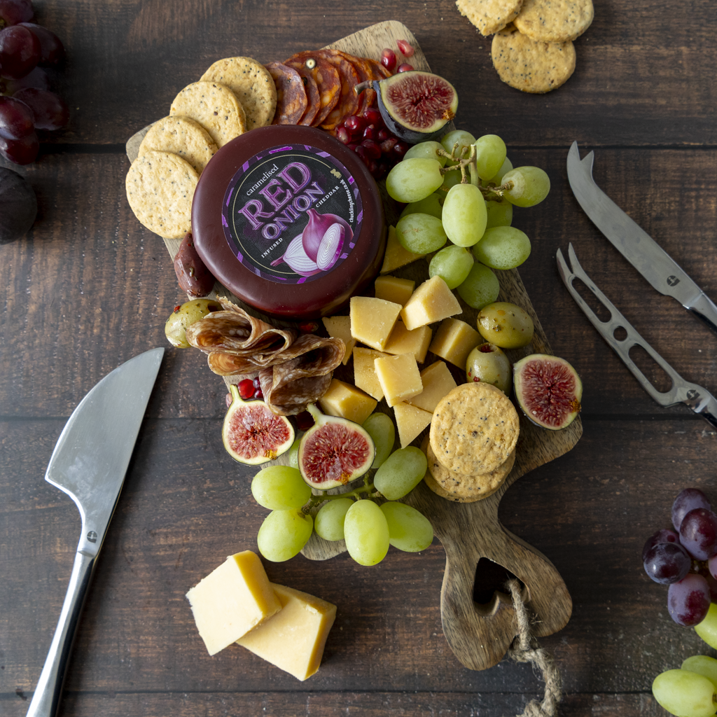 Caramelised Red Onion Cheddar Truckle grazing board with crackers, olives and cheese wedges