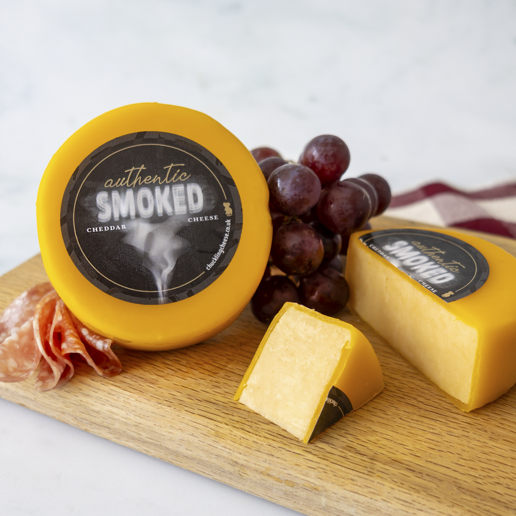 Authentic Smoked Cheddar Truckle with red grapes and sliced smoked cheddar