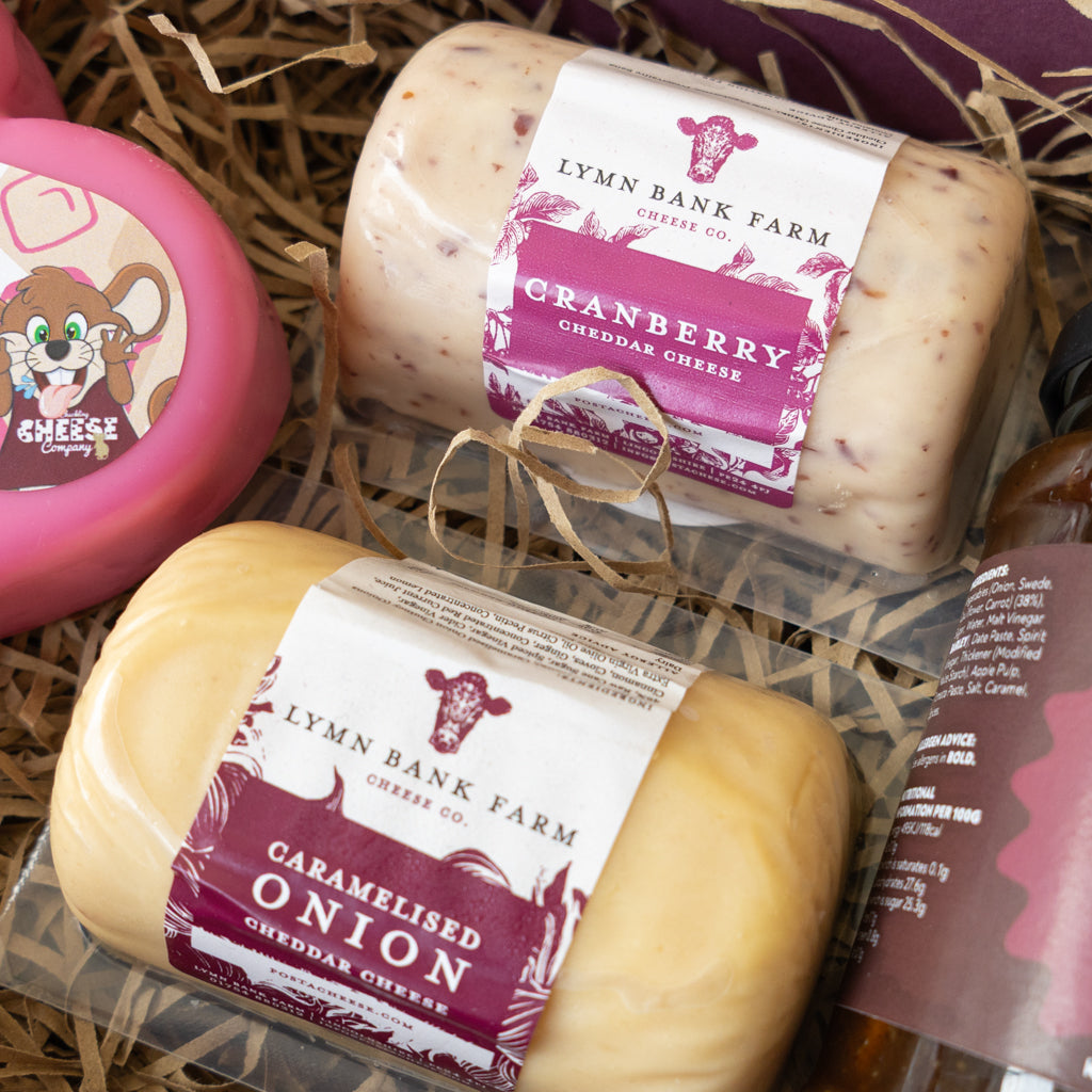 Close-up of Cranberry Cheddar and Caramelised Red Onion Cheddar inside the gift box.