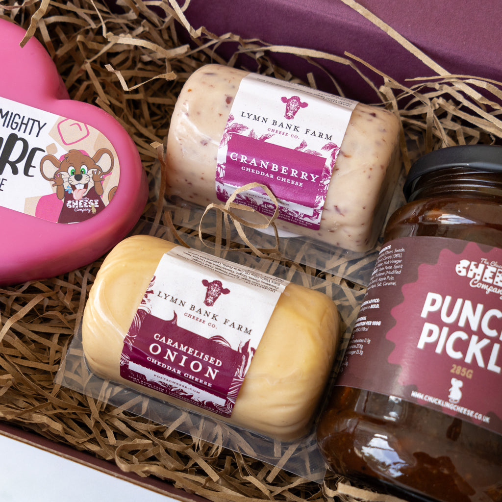 Open cheese gift box showing Cranberry Cheddar, Caramelised Red Onion Cheddar and Punchy Pickle.
