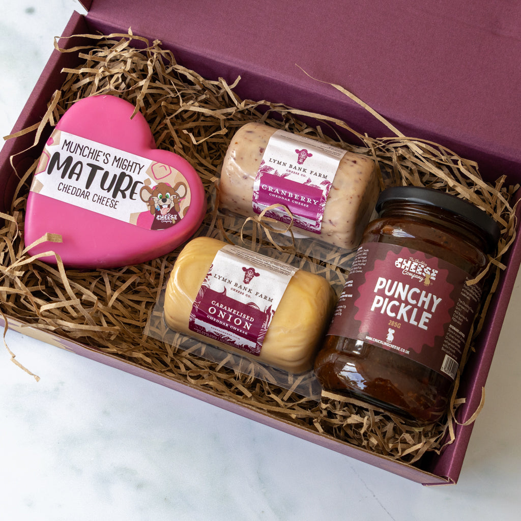 Open cheese gift box with Mighty Mature Cheddar, Cranberry Cheddar, Caramelised Red Onion Cheddar and Punchy Pickle.