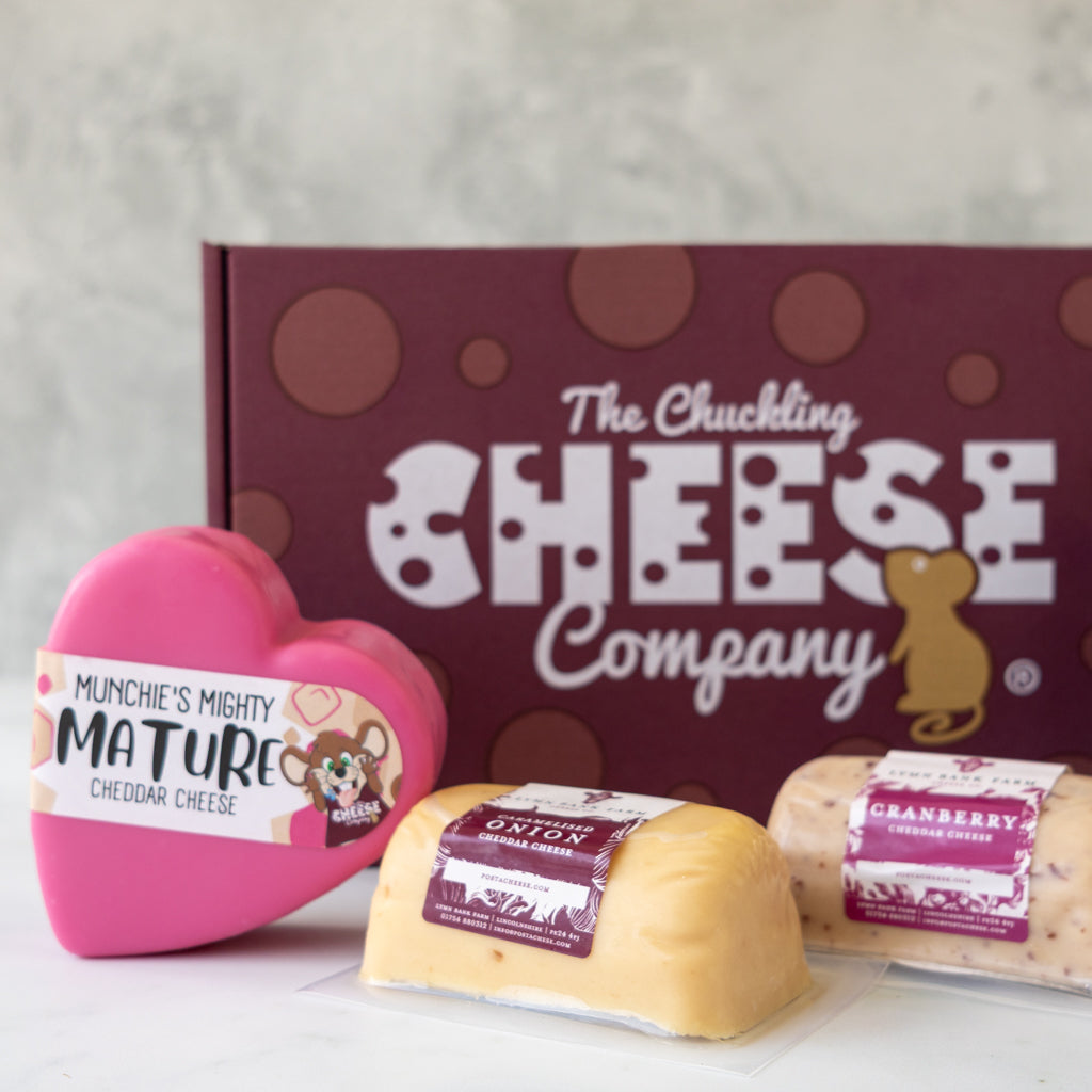 Cheese gift selection displayed with Mighty Mature Cheddar, Cranberry Cheddar, Red Onion Cheddar and Punchy Pickle.