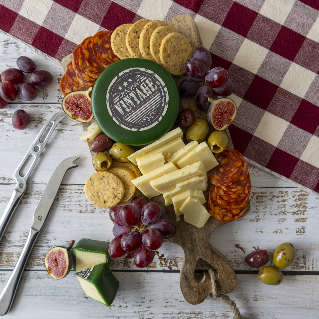 Intense Vintage Cheddar Truckle on a festive-style cheeseboard with fruit and crackers