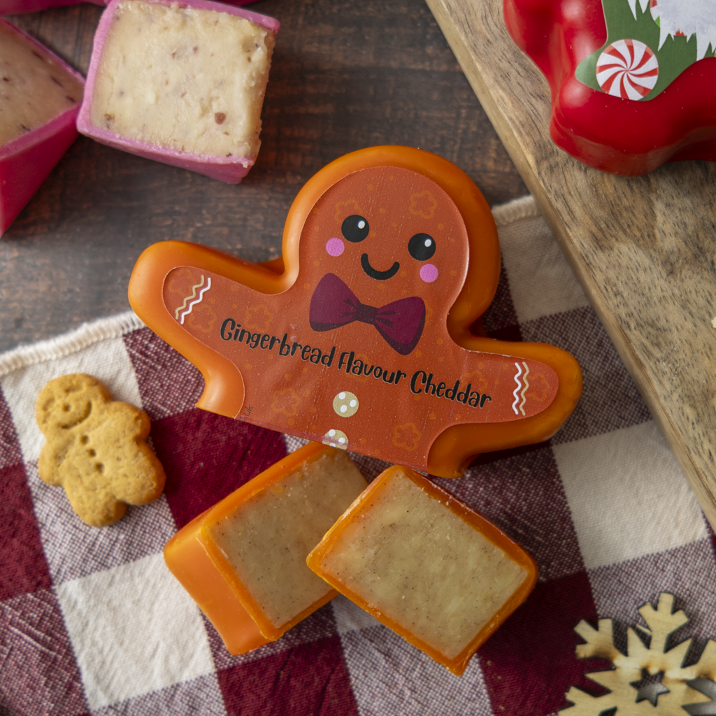 Gingerbread flavour cheddar in a festive gingerbread man-shaped wax, served with sliced cheese and a mini gingerbread biscuit.