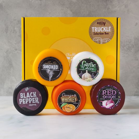 Truckle Selection Box with Smoked Cheddar, Garlic & Chive Cheddar, Black Pepper Cheddar, Orange & Whiskey Cheddar and Caramelised Red Onion Cheddar.