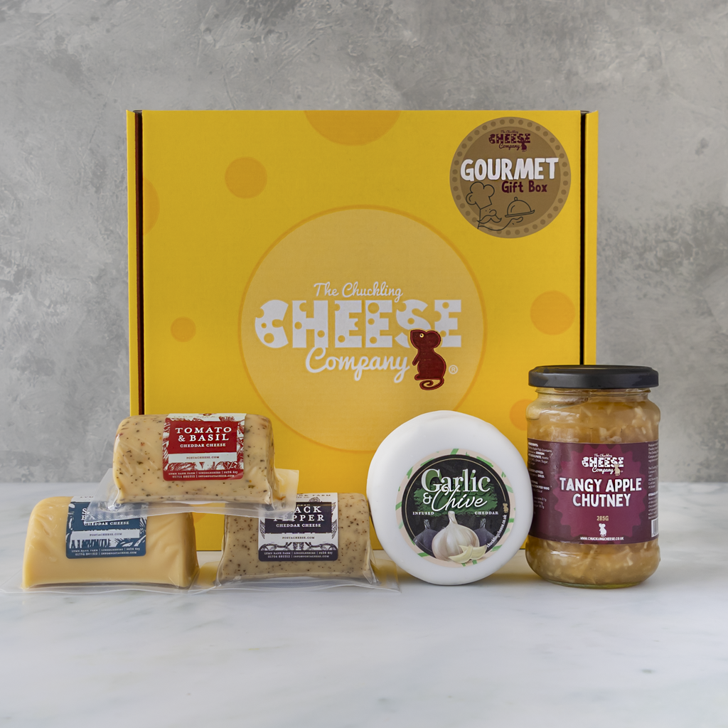 Gourmet Gift Box with Tomato & Basil Cheddar, Black Pepper Cheddar, Garlic & Chive Cheddar, assorted cheese and Tangy Apple Chutney.
