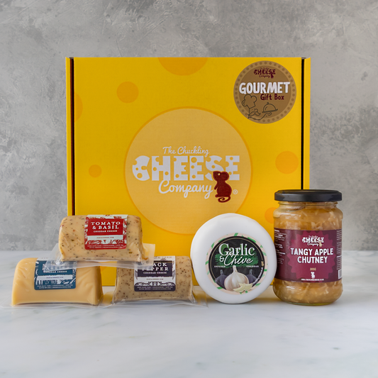 Gourmet Gift Box with Tomato & Basil Cheddar, Black Pepper Cheddar, Garlic & Chive Cheddar, assorted cheese and Tangy Apple Chutney.