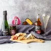 What to bring to a wine and cheese party blog main image with the Date Night Hamper open with cheese and accompaniments spread on a cheeseboard
