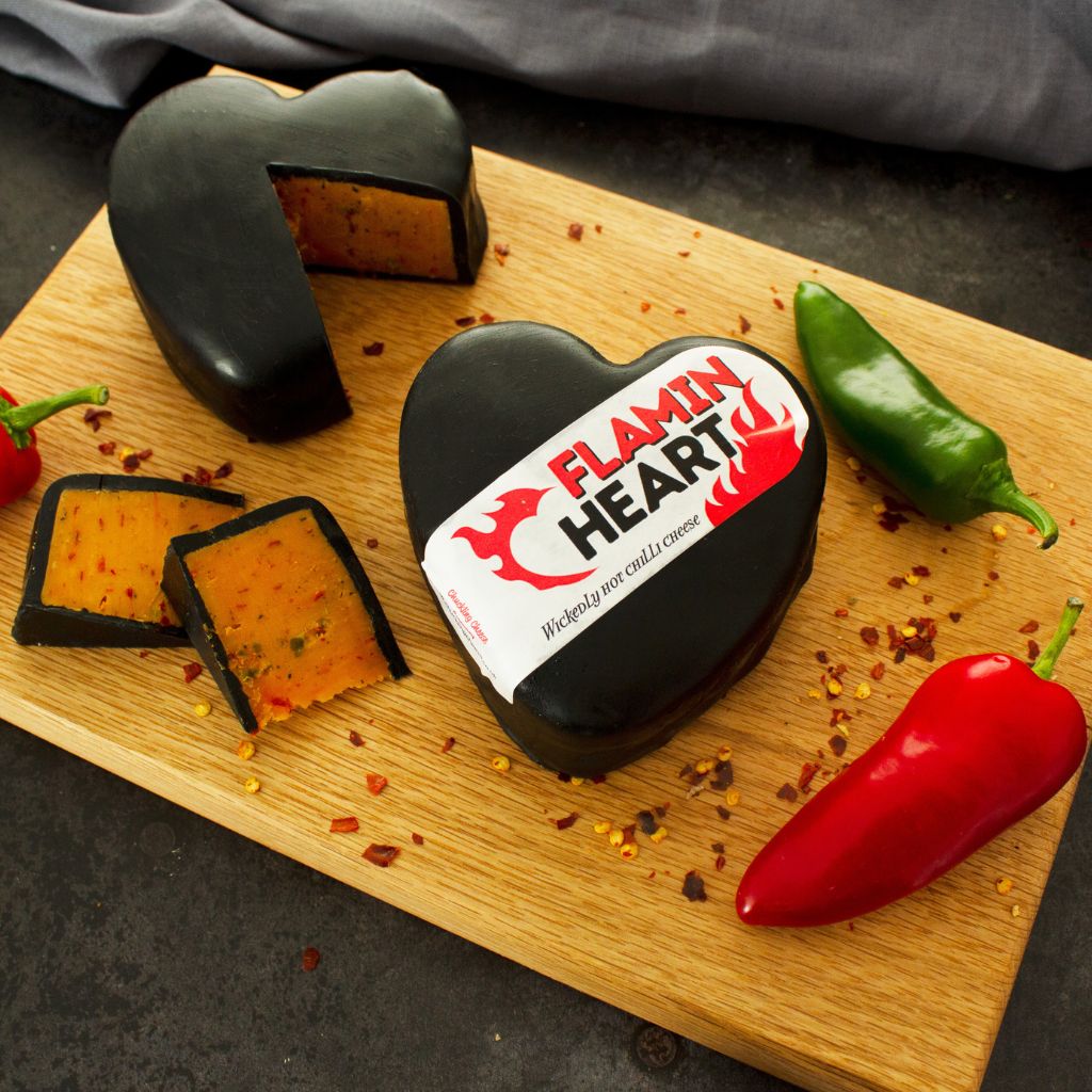 Flamin' Heart Cheese truckle on a cheese board with accompaniments
