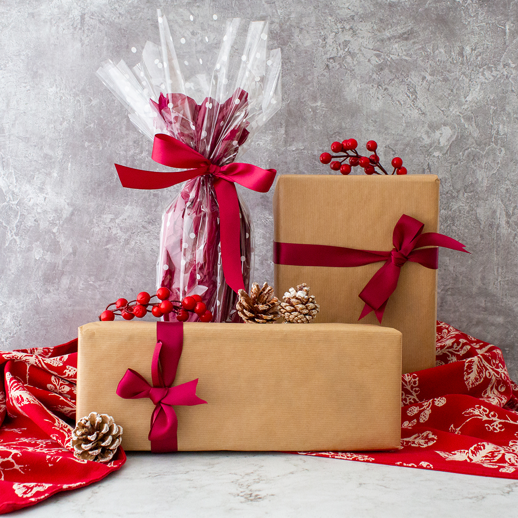 Scissors Cutting Christmas Ribbon While Wrapping A Present by