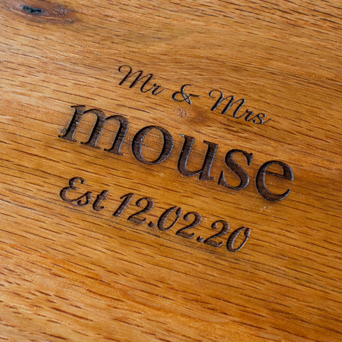 A close up image of the Chuckling Cheese Mr & Mrs Personalised Oak Cheeseboard. Personalise this cheeseboard with a surname and significant date.