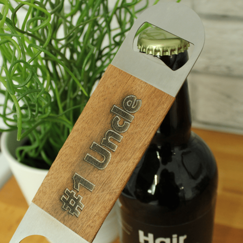 A Close Up Image Of The Chuckling Cheese Wooden Bottle Opener With Number 1 Uncle Engraved On It.
