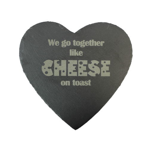 A chuckling cheese heart shaped, slate cheeseboard with we go together like cheese on toast engraved on it.