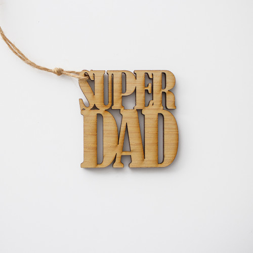 White background image of a single wooden gift topper laser cut to say super dad