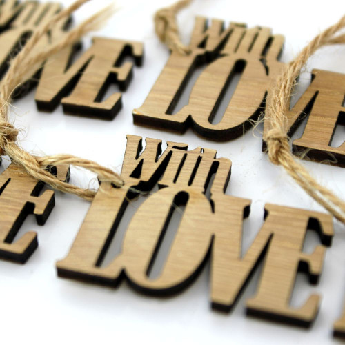 A close up image of the wooden gift tag engraved with With Love.