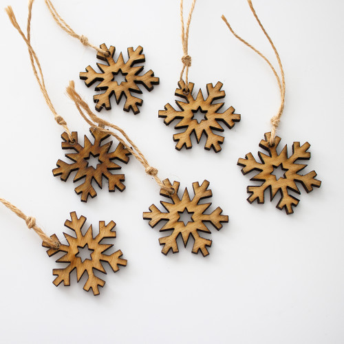 Close up image of a 6 pack of Wooden gift tags in the shape of snowflakes