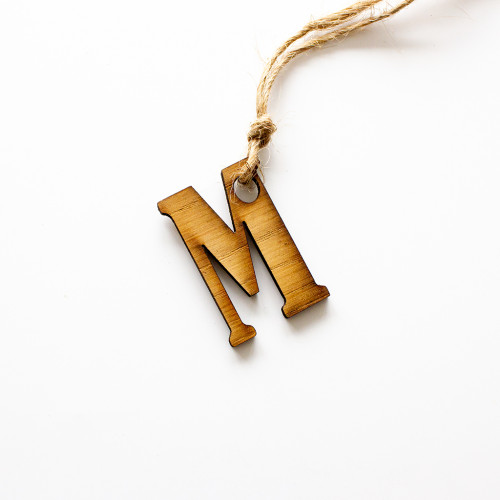 Gift tag made of wood, in the inital M, availble to purchase from The Chuckling Cheese Company