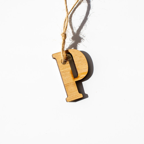 Gift tag made of wood, in the intial P, availble to purchase from the Chuckling Cheese Company