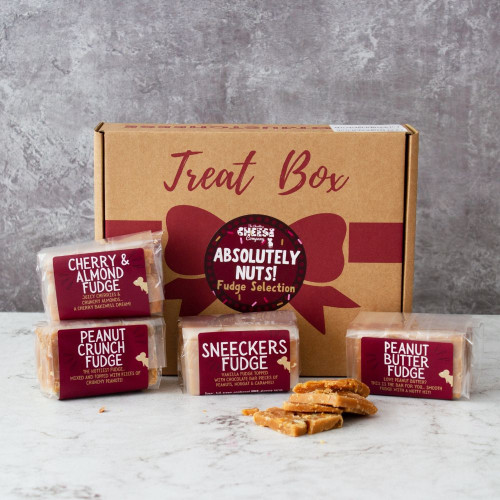 Lifestyle image of the Absolutely Nuts Fudge Box by The Chuckling Cheese Company including cherry and almond fudge, peanut crunch fudge, sneeckers fudge, and peanut butter fudge.