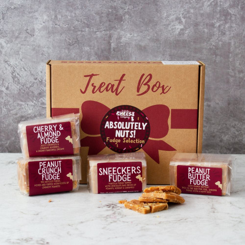 Lifestyle image of the Absolutely Nuts Fudge Box by The Chuckling Cheese Company including cherry and almond fudge, peanut crunch fudge, sneeckers fudge, and peanut butter fudge.