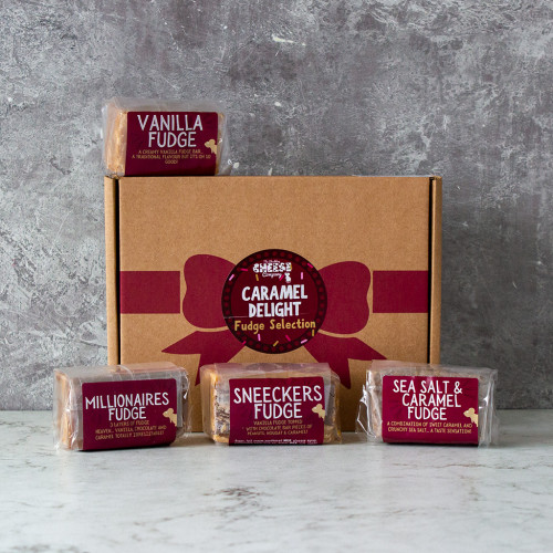 Lifestyle image of the Caramel Delight Fudge Box by The Chuckling Cheese Company including vanilla fudge, sea salt and caramel fudge, marz bar fudge, and millionaires fudge.