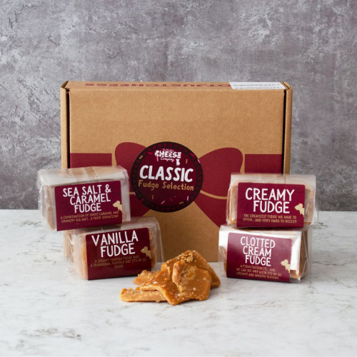 Lifestyle image of the classic fudge selection gift box by The Chuckling Cheese Company including sea salt and caramel fudge, vanilla fudge, creamy fudge, and clotted cream fudge.