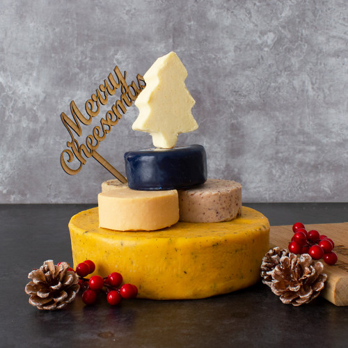 An image of the Christmas Cheese Tower topped with the Merry Cheesemas Wooden Cake Topper