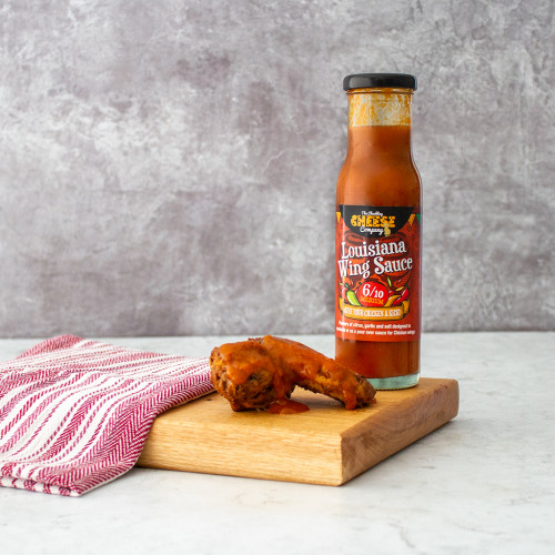 Louisiana Wing Sauce served with chicken wings, available at The Chuckling Cheese Company. Shop our range of chilli sauces and jams today!
