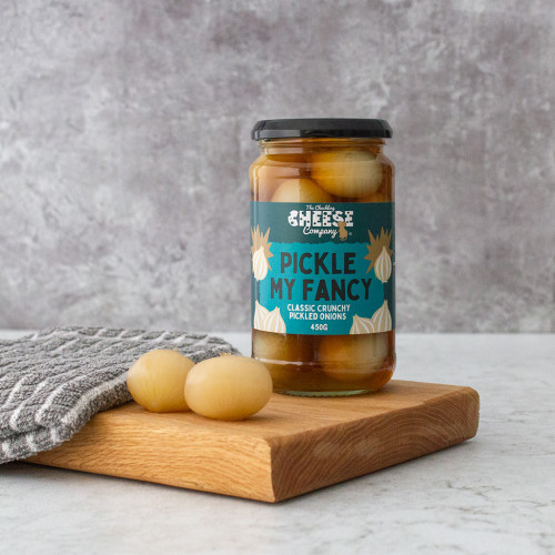Lifestyle image of a jar of pickle my fancy pickled onions by the chuckling cheese company
