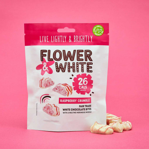A lifestyle image of a bag of Flower and White Raspberry and White Chocolate Meringue Bites.
