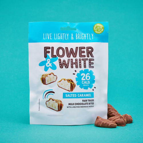 A lifestyle photo of a bag of Flower and White Salted Caramel Meringue Bites.