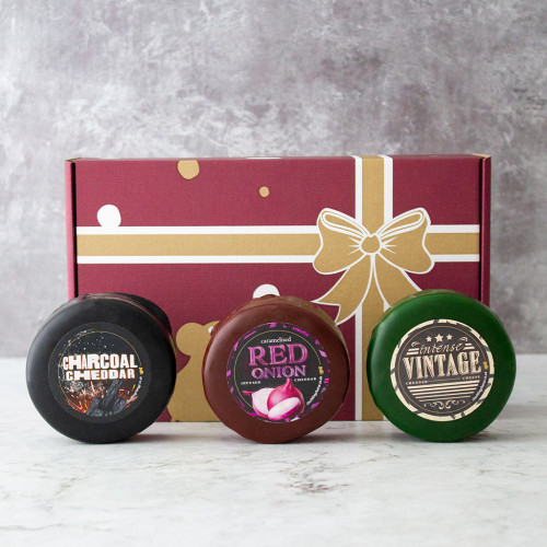 Front view image of the Truckle Best Sellers Gift Box including the Charcoal Cheddar, Caramelised Red Onion Cheese Truckle and Vintage Cheddar Cheese Truckle.