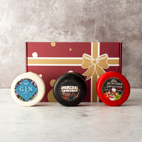 Grey background image of thr Truckle Selection Box 2 with 3 included cheddar truckles